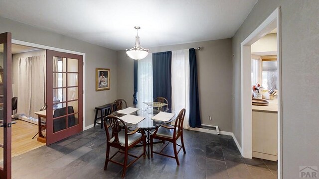 dining area featuring french doors and baseboards