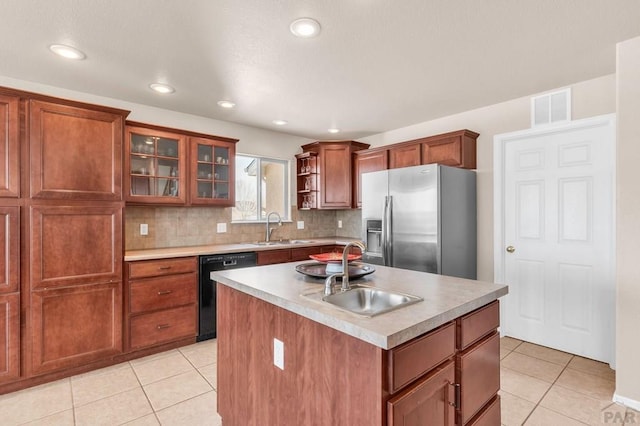 kitchen with black dishwasher, visible vents, a sink, and stainless steel fridge with ice dispenser