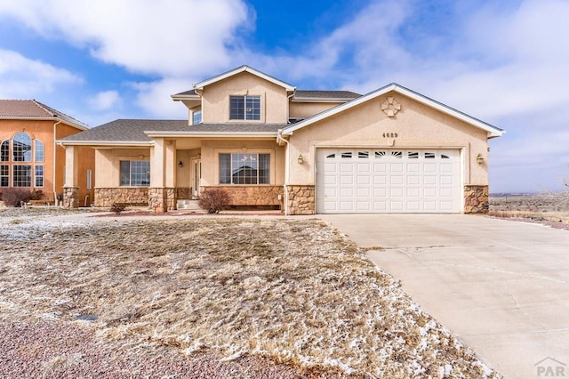 view of front of property with a garage, stone siding, driveway, and stucco siding