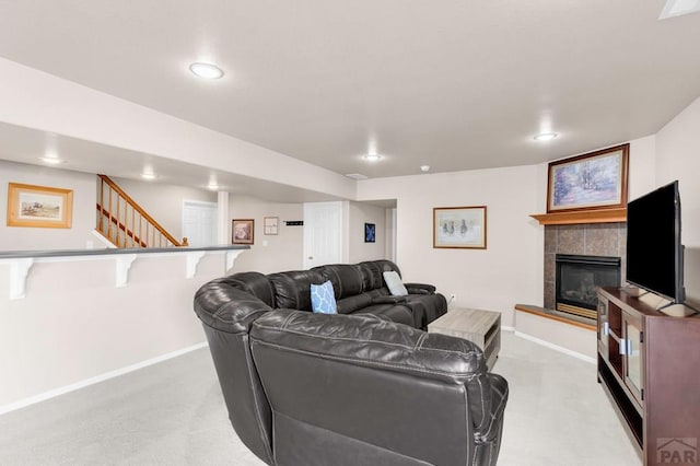 living area with recessed lighting, light colored carpet, a fireplace, and baseboards