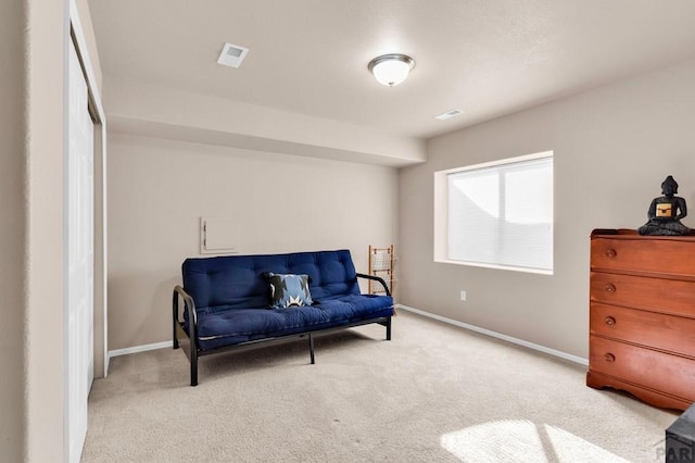 sitting room featuring carpet, visible vents, and baseboards