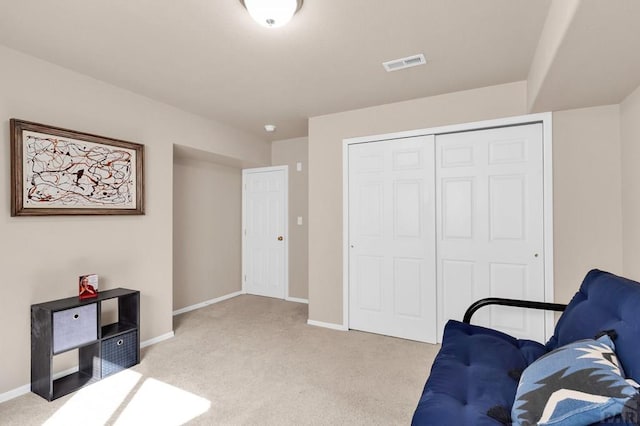 sitting room with carpet flooring, visible vents, and baseboards