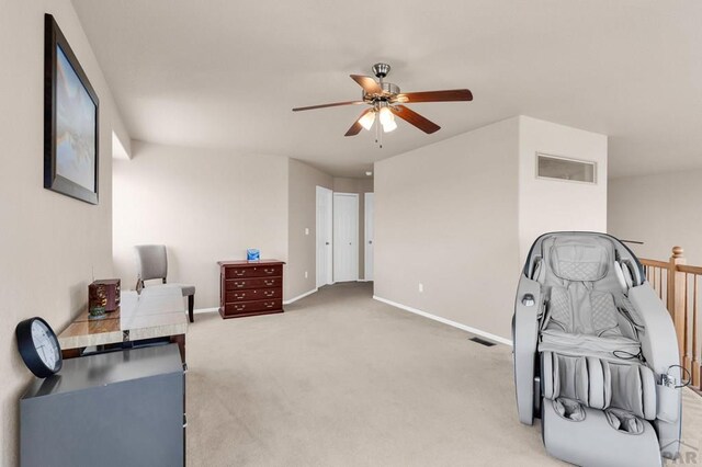 sitting room with ceiling fan, carpet flooring, visible vents, and baseboards