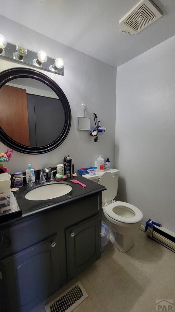 bathroom with visible vents, vanity, and toilet