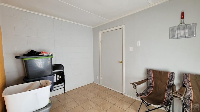 sitting room with light tile patterned flooring and crown molding