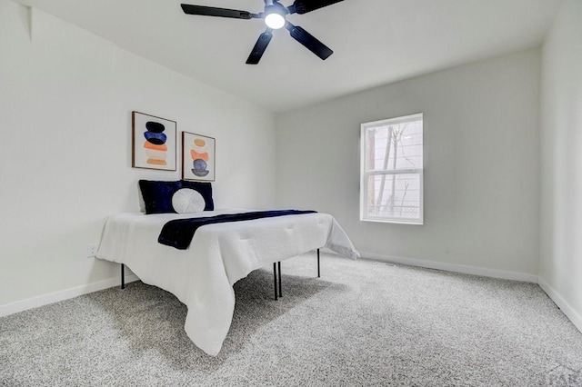 carpeted bedroom featuring a ceiling fan and baseboards