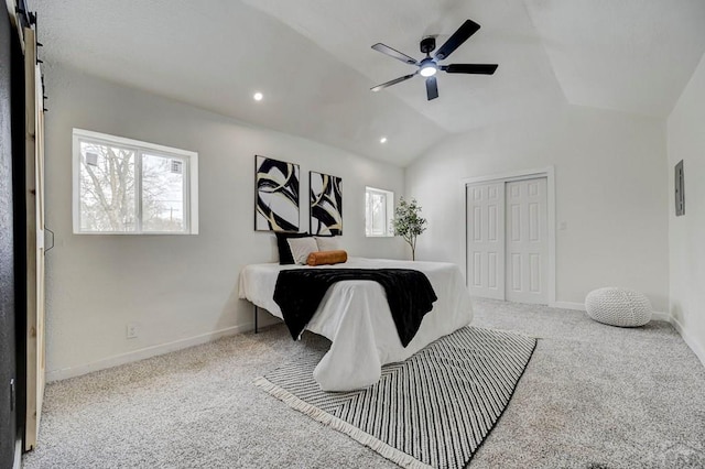 bedroom with lofted ceiling, light colored carpet, and baseboards