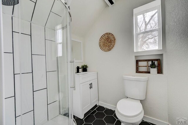 full bath featuring toilet, vanity, baseboards, tile patterned floors, and walk in shower