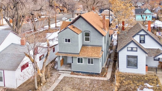 exterior space with roof with shingles, a residential view, and stucco siding