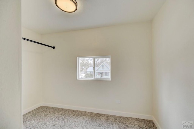 carpeted spare room with baseboards