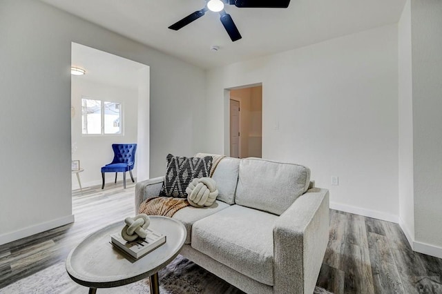 interior space featuring a ceiling fan, baseboards, and wood finished floors