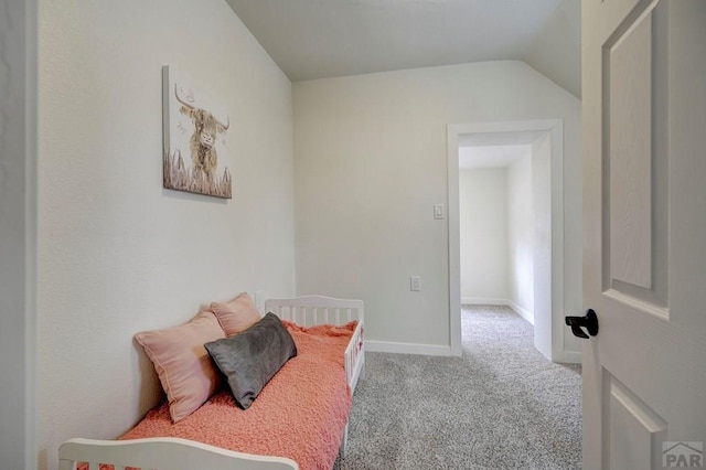 bedroom with carpet, vaulted ceiling, and baseboards