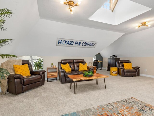 living area featuring lofted ceiling with skylight, carpet, and baseboards