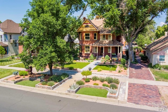 victorian house with covered porch and decorative driveway