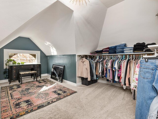 spacious closet featuring carpet floors and lofted ceiling