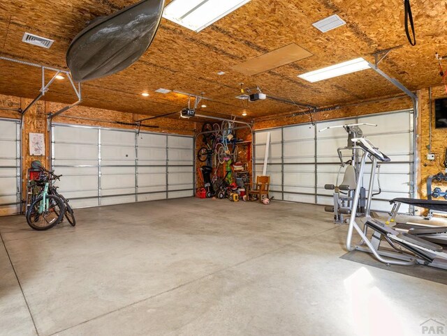 garage with visible vents and a garage door opener