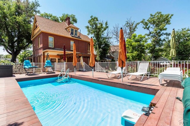 view of pool featuring fence, a fenced in pool, and a wooden deck