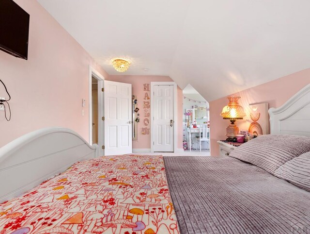 bedroom with lofted ceiling