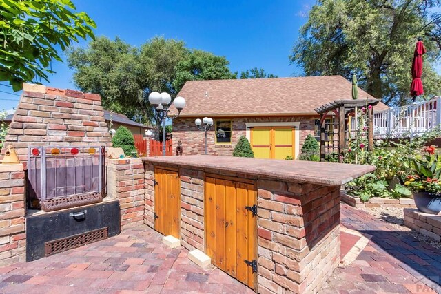 view of patio / terrace featuring a brick fireplace