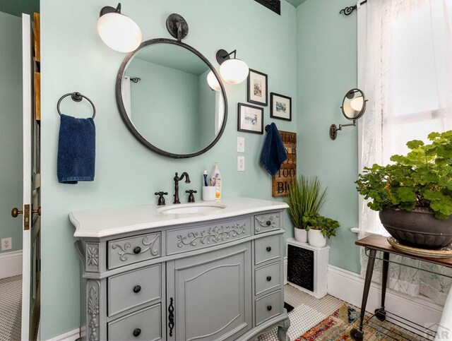 bathroom featuring baseboards and vanity