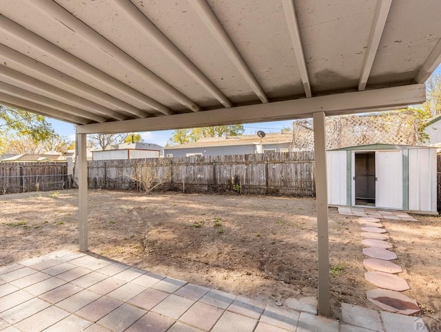 view of yard featuring a fenced backyard, an outdoor structure, a patio, and a storage unit