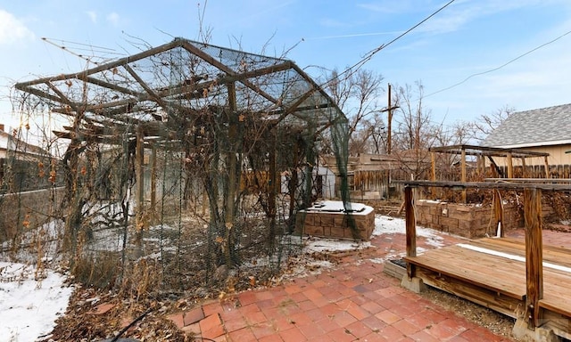 snow covered patio featuring fence private yard and an outdoor structure