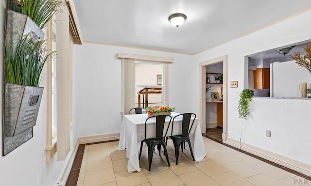 dining room featuring baseboards and light tile patterned floors