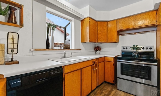 kitchen featuring stainless steel electric stove, a sink, light countertops, brown cabinets, and dishwasher