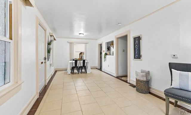 interior space with baseboards and light tile patterned floors