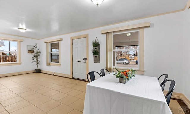 dining room featuring light tile patterned floors and baseboards