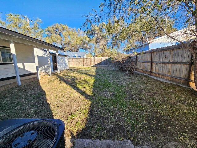 view of yard with cooling unit and a fenced backyard