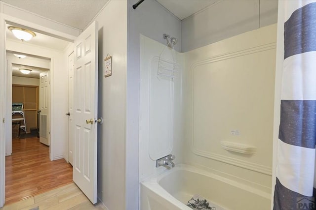 bathroom featuring shower / tub combo with curtain and wood finished floors