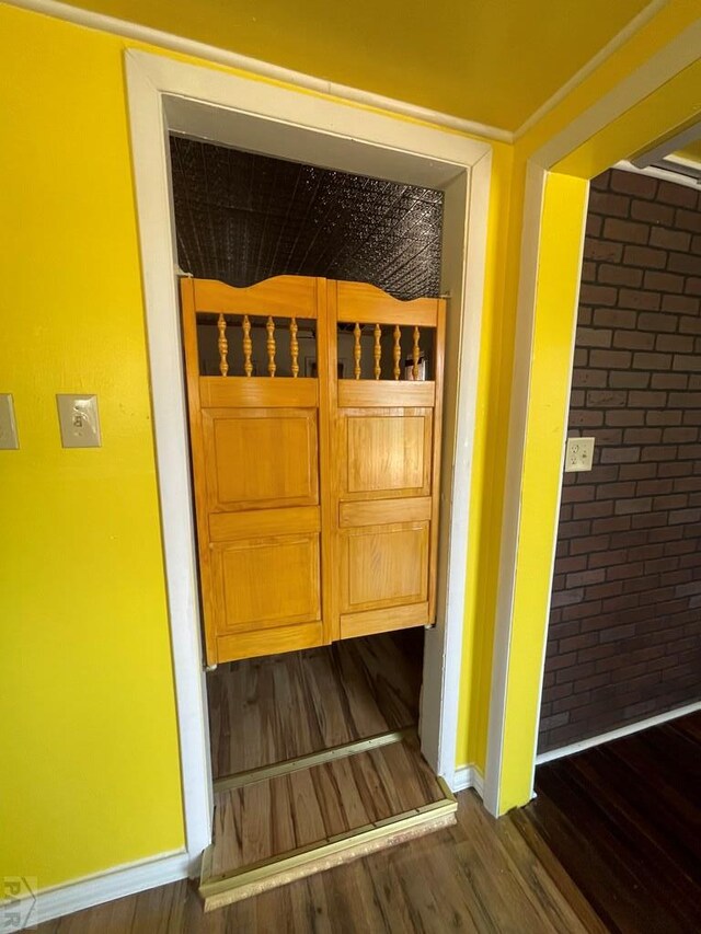 room details with baseboards and wood finished floors