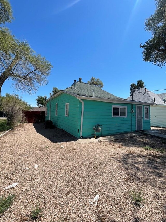 rear view of house featuring fence