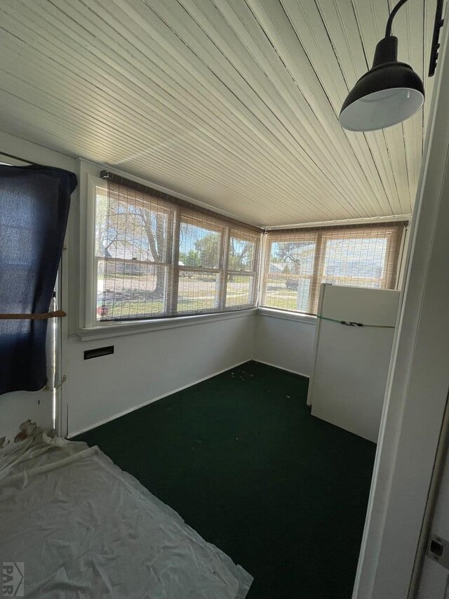 unfurnished sunroom with wood ceiling