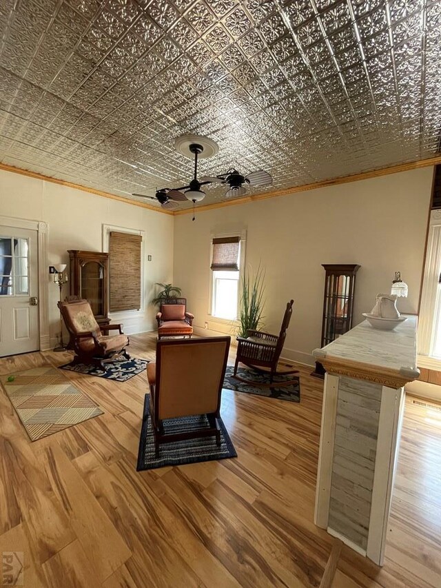 interior space featuring wood finished floors, an ornate ceiling, and crown molding