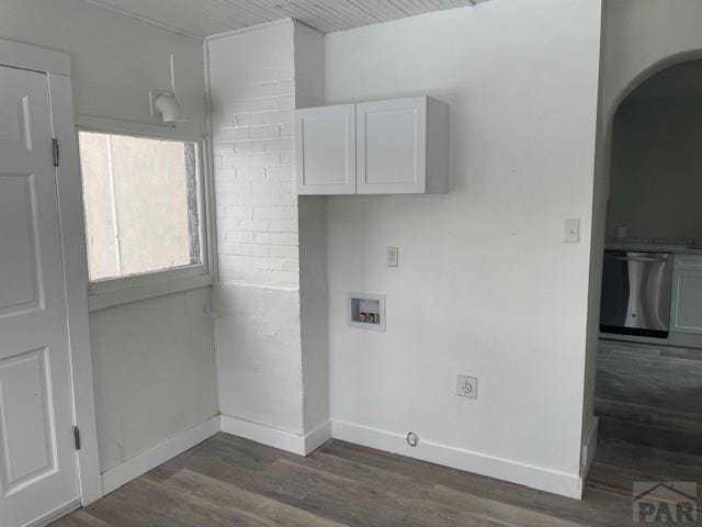 laundry room featuring arched walkways, hookup for an electric dryer, washer hookup, baseboards, and dark wood finished floors