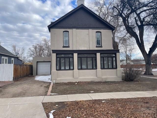 view of front of property with a garage, driveway, and stucco siding