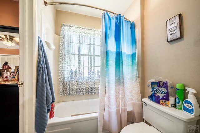 full bathroom with toilet, a ceiling fan, and shower / tub combo with curtain