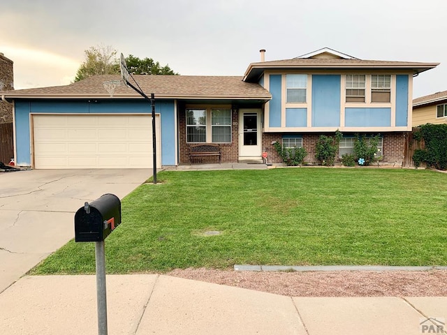 split level home featuring a garage, concrete driveway, brick siding, and a front lawn