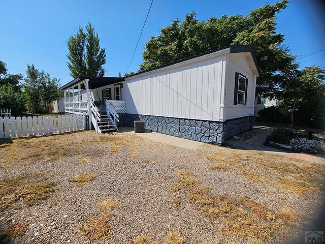 manufactured / mobile home with central air condition unit and fence