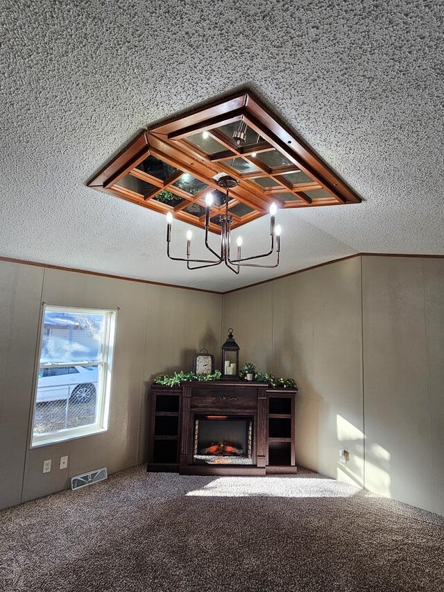 room details featuring visible vents, a fireplace, a textured ceiling, and carpet flooring