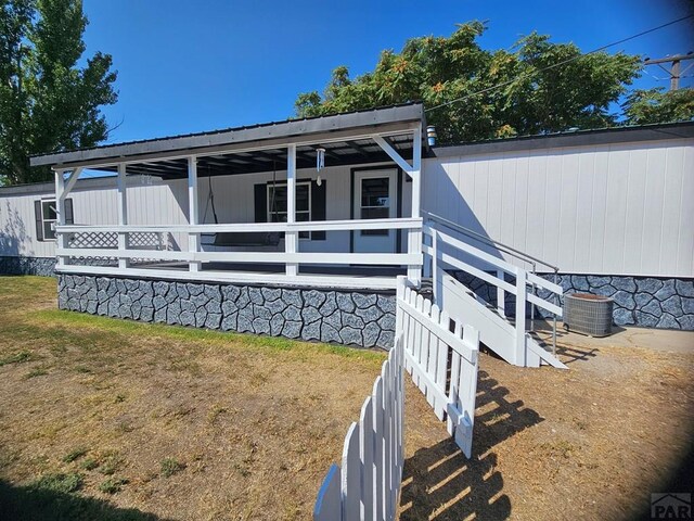 view of front of house with an outdoor structure, an exterior structure, and central air condition unit