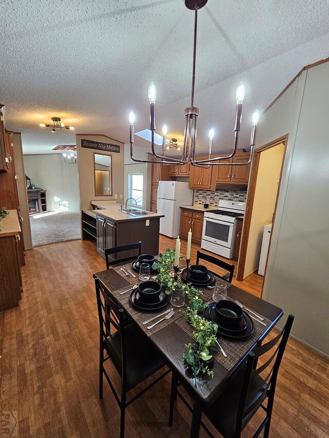 dining space with a textured ceiling, vaulted ceiling, and dark wood-type flooring