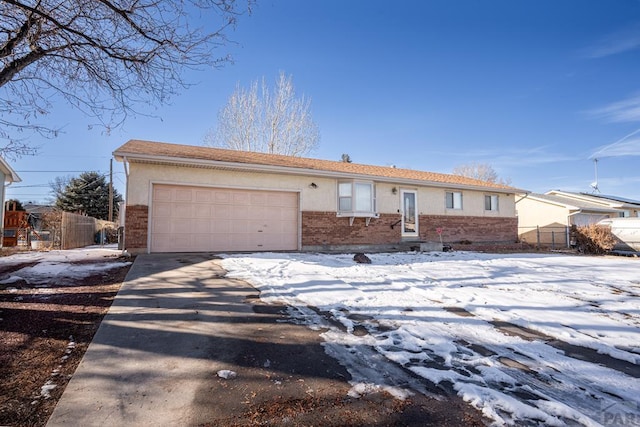 ranch-style house with a garage, driveway, brick siding, and fence