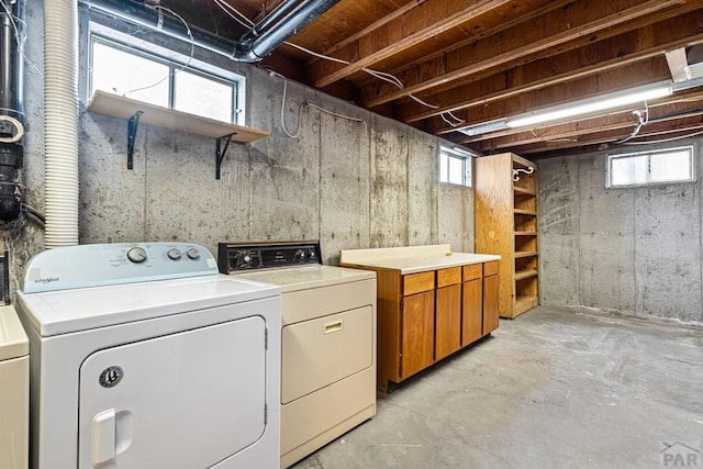 laundry room with washing machine and dryer and cabinet space