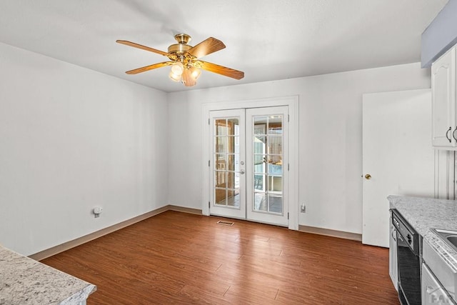 unfurnished dining area with baseboards, visible vents, ceiling fan, wood finished floors, and french doors