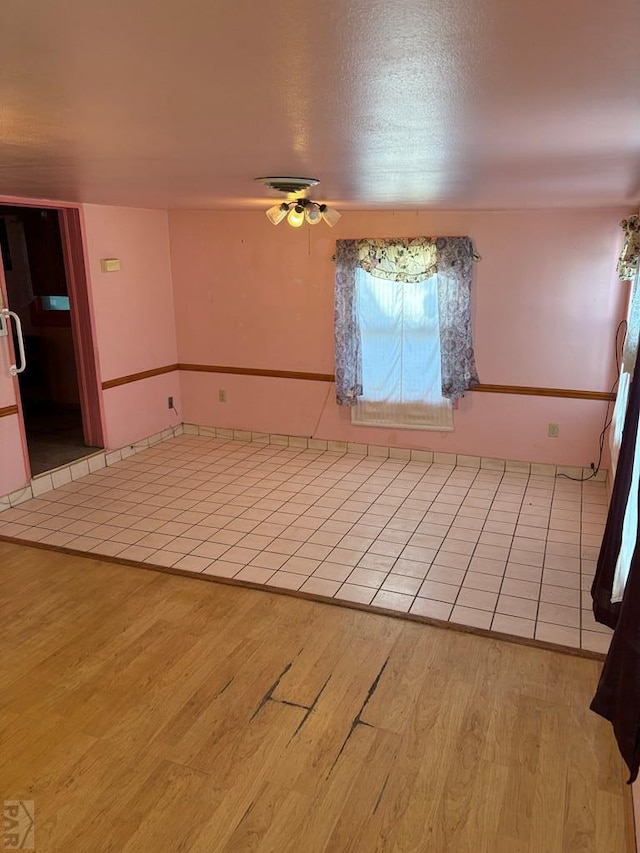 empty room with a ceiling fan and light wood-style floors