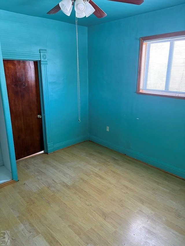 empty room with light wood-style flooring and a ceiling fan