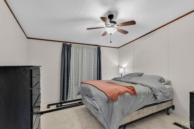 bedroom with crown molding, a ceiling fan, and light colored carpet